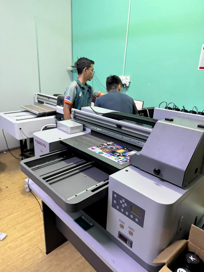 ezLASER.my printer producing a full-colour print in a customer's shop